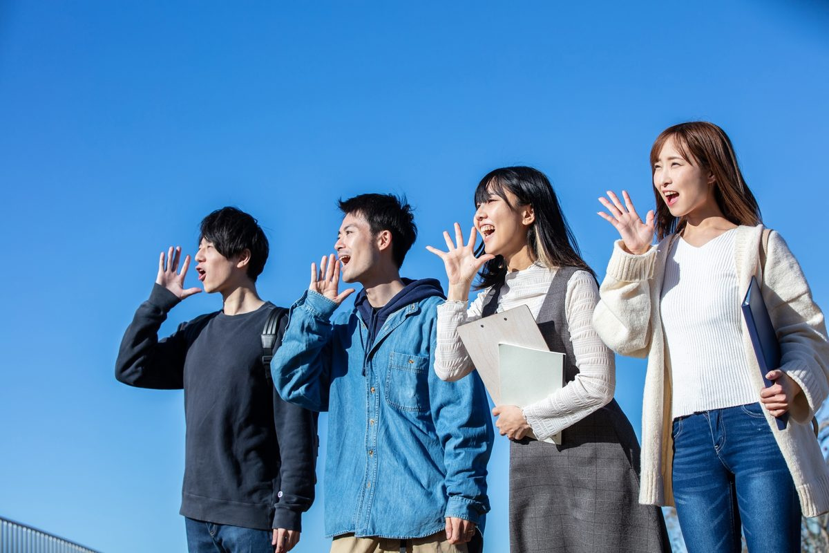 青空の下で過ごす大学生