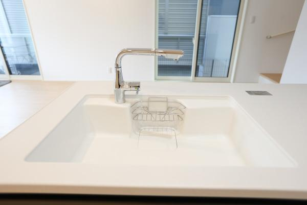 AG-HOUSE 萩原A棟のキッチン|シンプルなデザインのシンクが配置されています。広々としたスペースが確保されていてお手入れもしやすい形状です。水栓もスタイリッシュな印象で空間に調和しています。キッチン周辺の明るさも感じられます。