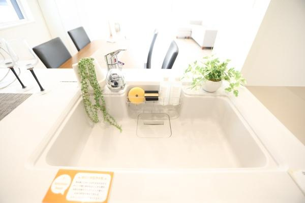 タマタウン青葉台　2号地のキッチン|明るく清潔感のあるキッチンシンクです。シンプルなデザインでお手入れもしやすくなっています。グリーンや小物がアクセントになっています。