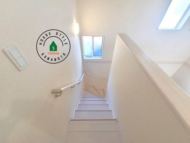 熊本市南区良町5丁目第1-4棟(1号棟)の内観：施工例|＜手すり付階段＞手すりがないと階段の昇り降りで危険なことはもちろん、壁に手をつきながら歩くことで壁紙が汚れやすくなります。すべての方に快適に昇り降りしていただくため、手すりを設置しました。