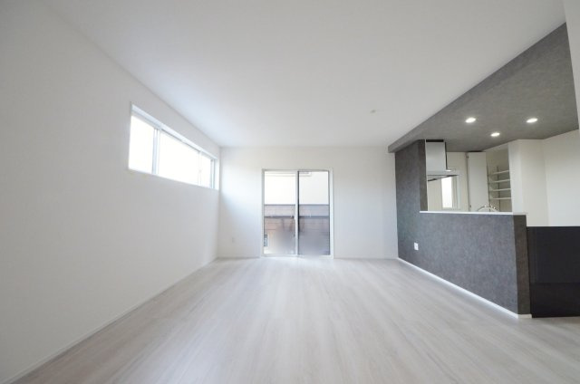 皆賀二丁目の居間・リビング|陽当たりが良く、窓の多いリビング空間。オープンタイプの対面式キッチンでリビングが隅まで見渡せます。キッチンにいながら小さなお子様にも目が届き安心です。