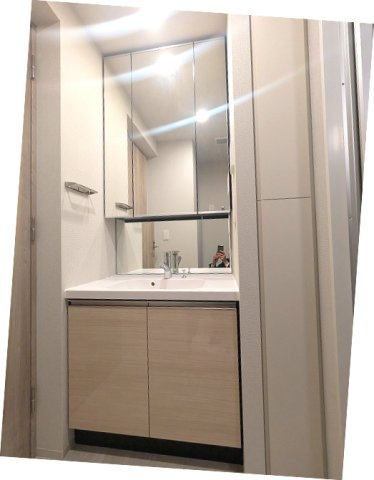 geo ent上野稲荷町の洗面所|トイレと独立した洗面脱衣室に洗濯機置場あります、三面鏡付ハンドシャワー付洗面台、洗濯機置場は排水口のお手入れしやすい様に手前中央に配置し、足高の防水パンです