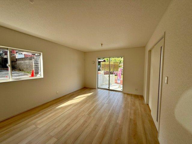 クレイドルガーデン那覇市識名 第３・１号棟の居間・リビング|二面採光で明るく広々としたLDK16帖／駐車場からも出入りできる大きな掃き出し窓