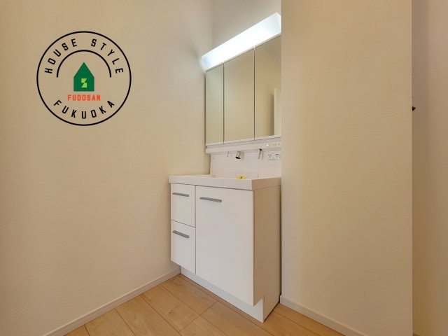 古賀市千鳥6丁目第2-3棟(3号棟）の内観：施工例|毎日使うものだから清潔な空間を保ちたい水回り。洗面にはそんな願いを解消させてくれる収納アイデアが満載です。三面鏡の裏側にはキャビネットが現れ小物から背の高い物まで収納できます。