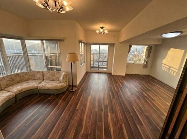 高知市九反田　中古マンションの居間・リビング|大きな窓が並ぶリビング。陽だまりに包まれる、心地よい暮らし