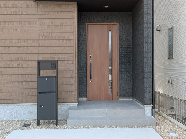 リナージュ美浜町奥田　2号棟の玄関|ナチュラルで落ち着いた雰囲気の玄関は居住者の帰り、訪れる方を優しく迎えてくれます。サムターンセキュリティー付き玄関扉で安心。ポストは外出中も荷物を受け取ることができて便利な宅配ボックス付き♪
