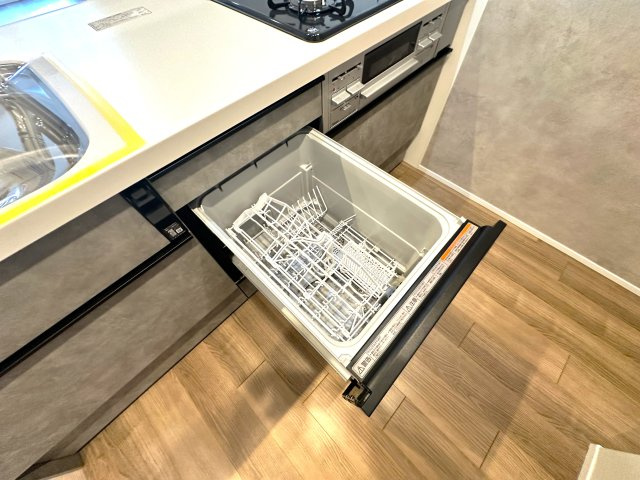 洋伸東大島マンションのキッチン|面倒な後片付けは食洗機におまかせ。空いた時間には、ソファでテレビを観ながらゆったりひと息。家事の負担を減らして、毎日に小さな余裕と心地よさをもたらします。