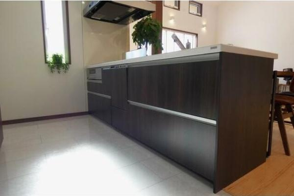 HT久原4号地のキッチン|シンプルな色合いが落ち着いた印象のキッチンです。直線的なデザインが空間をすっきりと見せます。広々としたカウンターで作業のしやすさが感じられます。自然光が入る位置にあり明るさが確保されています。