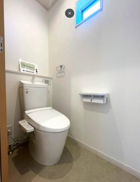 HT久原1号地のトイレ|明るい窓付きで自然光が差し込むトイレです。壁や床は清潔感のあるシンプルな色合いとなっています。温水洗浄便座が備え付けられており便利にお使いいただけます。