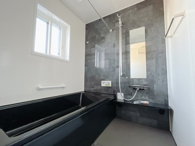 【新築戸建】太田市飯塚町の浴室|■浴室｜足を伸ばしてゆったりと入浴ができる1坪タイプのバスルームです♪備え付けの棚には家族一人一人のシャンプーを分けて置くことができます♪バスルームをいつもすっきりと使えますね♪