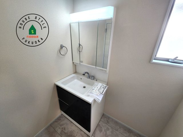 福岡市南区長住5丁目第8-3棟（2号棟）の内観：施工例|毎日使うものだから清潔な空間を保ちたい水回り。洗面にはそんな願いを解消させてくれる収納アイデアが満載です。三面鏡の裏側にはキャビネットが現れ小物から背の高い物まで収納できます。