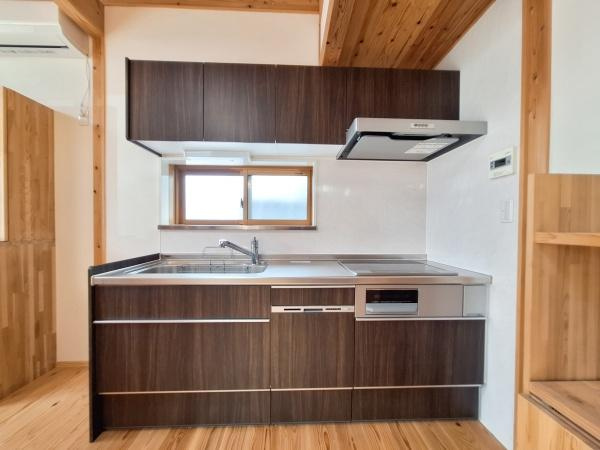 角子原二丁目　戸建てのキッチン|シンプルなデザインのキッチンが印象的です。窓からの光が明るさをもたらします。収納スペースが多く家事がしやすい環境です。木目調の扉が空間に落ち着きを与えています。