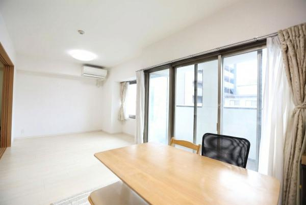 ラグジン高松西の居間・リビング|大きな窓から光が差し込む明るいリビング空間です。白を基調とした内装が開放感を演出しています。バルコニーへも直接アクセスできます。