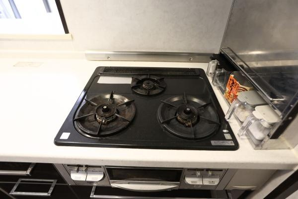 ラグジン高松西のキッチン|三口コンロが設置されており同時に複数の調理が可能です。シンプルなデザインでお手入れがしやすい仕様です。作業スペースが確保されているため調理が快適に行えます。