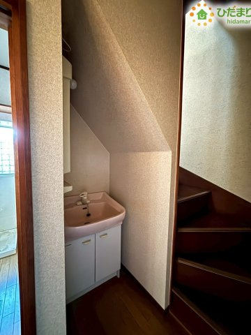 熊谷市柿沼　中古一戸建ての独立洗面台|階段下の空間を上手に活用した洗面スペースです！コンパクトながら鏡の下に収納扉があり、洗面用具や洗剤などを隠してしまえます♪廊下からすぐにアクセスできるため、帰宅後の手洗い習慣もバッチリです♪