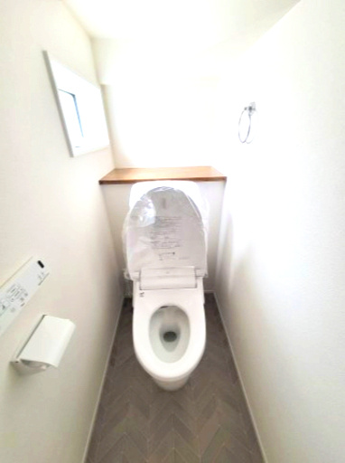 売新築戸建　沼津市東椎路のトイレ|トイレには窓があり明るい室内です。棚があるのでトイレットペーパーの予備や芳香剤が置けて便利です。