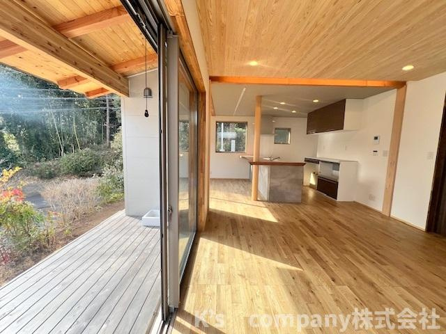 ■平塚市出縄　新築戸建●の居間・リビング|リビングの窓からお庭を望めるプライベート空間のデッキには、庇付きでリゾートを思わせる雰囲気があります◇