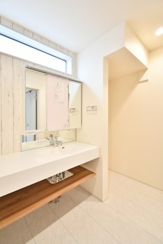 蓮田市馬込2丁目　全1棟の独立洗面台|清潔感溢れるフルフラットカウンターのワイド洗面台。継ぎ目のないデザインでお手入れも簡単です。上部に窓を配し、明るく開放的なサニタリー空間を実現。下部のオープンスペースは自分好みに活用可能です。