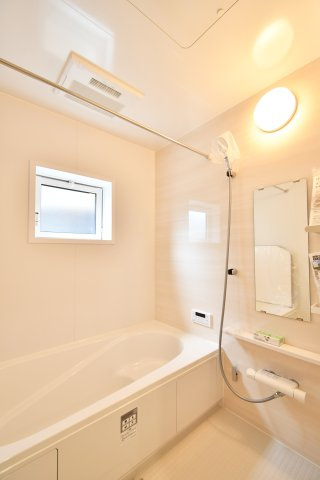 蓮田市馬込2丁目　全1棟の浴室|1坪以上のゆとりある浴室で一日の疲れを癒せます。雨の日の衣類乾燥に便利な浴室換気乾燥機も標準装備。窓付きで換気効率も良く、木目調のアクセントパネルが落ち着いたバスタイムを演出します。