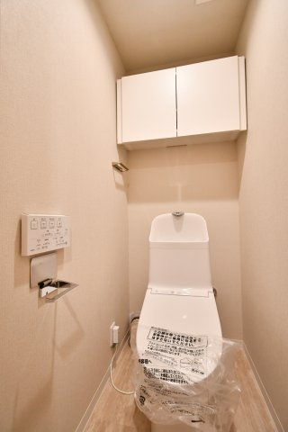サンマンション北本1号館のトイレ|トイレ：奥行きにゆとりがあり、圧迫感の少ないトイレスペース。吊戸棚付きで、トイレットペーパーなどの備品補充も楽々行えます。掃除用具をしまうと清潔感も消す事ができ、イマドキなお部屋にできます。