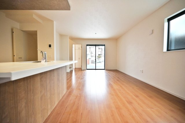 テラシエ尼崎市久々知1丁目新築一戸建て｜4LDK＋駐車1台可の居間・リビング|ダイニング側からリビングに向かって撮影した写真です。大きく開けた窓から明るい陽射しが差しこんでくる空間になっています。家族の笑い声が聞こえてきそうです。