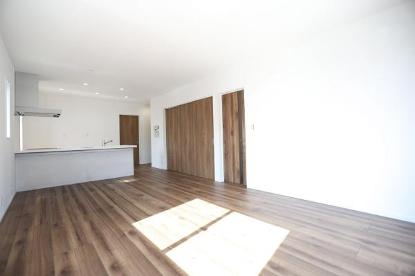 P-TELAS牧１丁目3号地の居間・リビング|リビングは開放感のある広々とした空間です。床材の木目が美しくナチュラルな印象を与えます。大型の窓からはたっぷりと光が差し込みます。収納スペースも充実しており整理整頓がしやすいです。