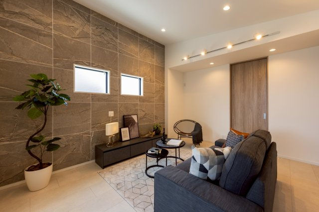 神戸市灘区高尾通1丁目新築一戸建て│3LDK+駐車2台可(車種制限有)の居間・リビング|リビングは勾配天井を採用しており、広がりを持たせた抜け感のあるリビングに仕上がりました。アクセントクロスの窯業系タイルはどんなインテリアとでも相性の良く、空間の住み分けや飽きの来ない生活を実現させます