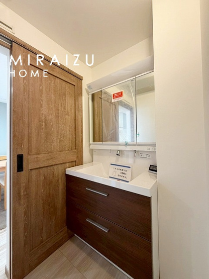 【洗面所】 | 洗濯機置き場と脱衣スペースもしっかりと確保されている洗面室、洗面コーナーは、窓から陽も差し明るく開放的な造りです。家事導線も良いので洗濯物やお湯はりもストレスフリーに毎日家事を楽しめそうです。
