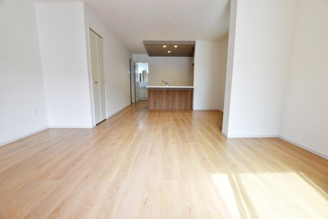 テラシエ立花3丁目新築一戸建ての居間・リビング|リビング側からキッチンに向かって撮影した写真です。19.6帖のLDKはダイニングテーブルとソファーセットを配置しても余裕の広さです。