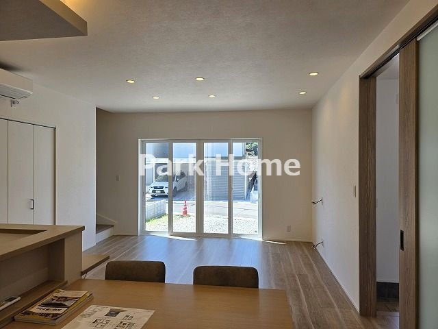 高知市福井町 -E号地- 新築戸建ての居間・リビング|１F:17.2LDKの広々とした空間に南向きの明るい陽光が差し込むため、日中は照明を消してエコに過ごすことができ、家族が自然と集まりたくなるような開放的で心地よい憩いのリビングが実現します。