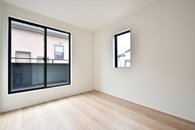伊奈町小室10期　全1棟の洋室|洋室②：バルコニーに面した大きな窓と、サイドの小窓が開放感を演出。5.25帖ながら、明るい色調のフローリングが空間を広く見せます。子供部屋や趣味の部屋として、自分らしい時間をゆったりと過ごせる一部屋。