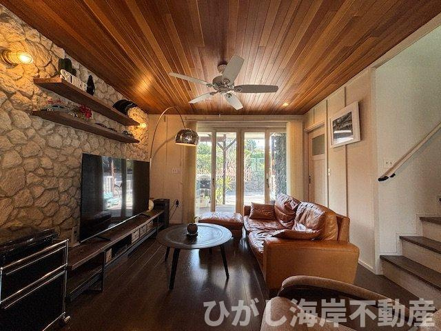 藤沢市鵠沼海岸1丁目　中古戸建の居間・リビング|大きな掃き出し窓から光が差し込む、温もりあるリビング。
木目天井と石張りのアクセントが、上質で落ち着いた時間を演出します。

