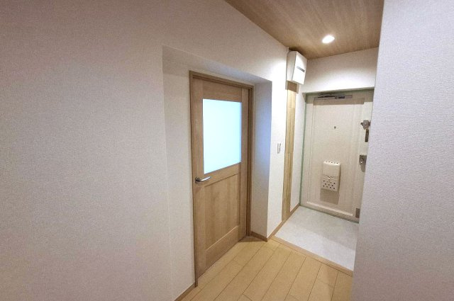 泉北茶山台第1次住宅11号棟の内装|玄関の壁一部には、調湿・脱臭効果が期待できるエコカラットを貼りました。