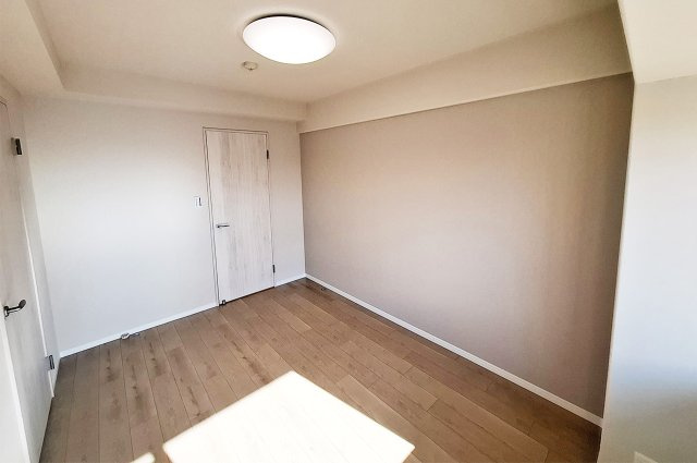 ロイヤルアーク泉ヶ丘の寝室|洋室1：落ち着きのある淡いグレーのアクセントクロスを新調。