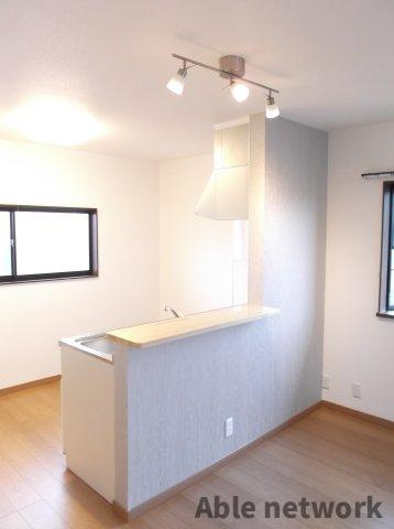 神栖市深芝南３丁目のアパートの居間・リビング|カウンターキッチン（アクセントクロス）