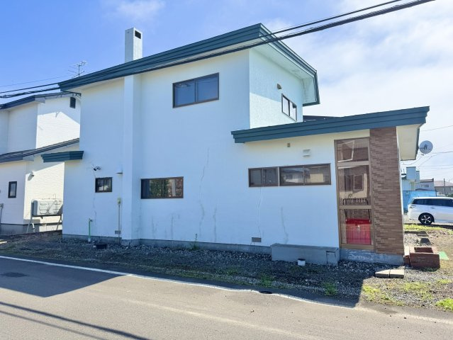 【角地の開放感】昭和エリアの利便性と、木の温もりあふれる室内が魅力の住まいの前面道路含む現地写真|建物の裏側までゆとりある敷地。雪解け後の活用も楽しみな広さ。