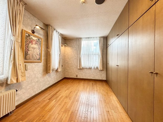 旭ヶ丘３丁目　戸建の洋室|壁一面の収納を備えた約8帖の洋室。豊富な収納力でお部屋を広く使えます