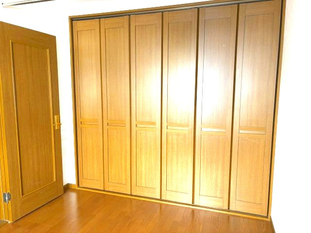 北見市東三輪５丁目５番地４９　中古売家 外１筆の収納|1階洋室のクローゼットは、折れ戸なので扉を全開にすると、収納内部全体が見渡せます。大きな荷物もスムーズに出し入れでき、 扉を閉じるとフラットになり、部屋がスッキリと見えます。