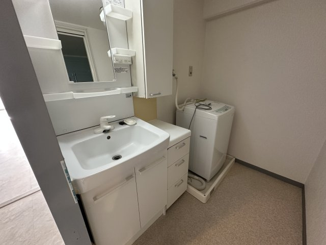 サンヴェール朝霧ヶ丘の独立洗面台|【洗面化粧台】洗面台横にキャビネットが備わっています。タオルや衣類、洗濯用品などをまとめて保管でき、すっきりとした洗面スペースを保てそうです。
