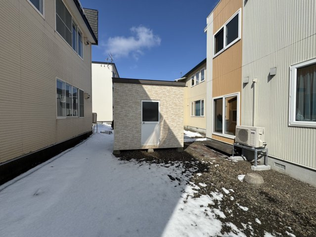 陽光注ぐモダン邸宅。昭和中央の利便性と60坪の開放感を楽しむゆとりの家♪の外観|便利な外部物置付き。タイヤや除雪道具もすっきり収まる裏庭。