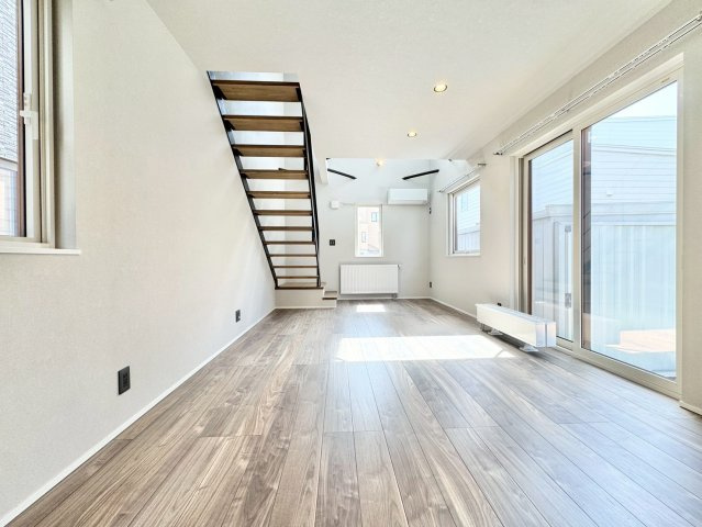 月寒東4条18丁目　一戸建ての居間・リビング|北西側から撮影したリビングスペース。南面の吹抜けや窓から明るい日光が差し込みます♪
※バーチャル加工により一部家具等を削除しております。