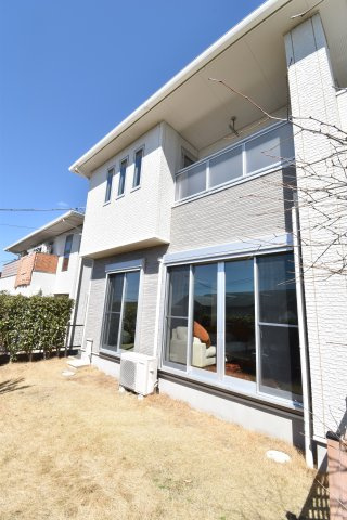 南ひな壇に建つ収納充実のモダン住宅の庭|天然芝でプライバシーの高い庭です。玄関までも素敵なエントランスでワクワク感があります。