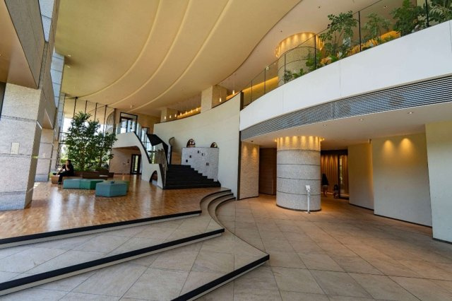 【ガーデンエントランス】階段上のランプテラスにはカウンター席のワーク・読書スペースがあり、書棚は大手書店と提携し、月に1回の雑誌等の入れ替えあり。
