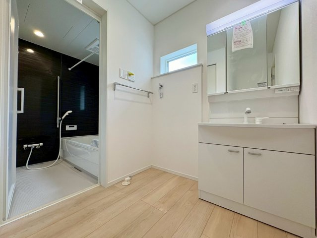 香美市土佐山田町東本町第1　1号棟新築戸建ての独立洗面台|三面鏡付き洗面化粧台とゆとりある洗面脱衣室。バスルームと隣接し、毎日の身支度や家事動線もスムーズです。