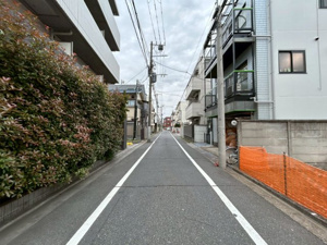 【前面道路含む現地写真】 | 舗装された平坦な前面道路は、ベビーカーの移動や自転車の走行もスムーズです。西側の広い道路幅により、カースペースへの駐車もストレスなく行えます。毎日の送り迎えや外出がより快適になる環境です。