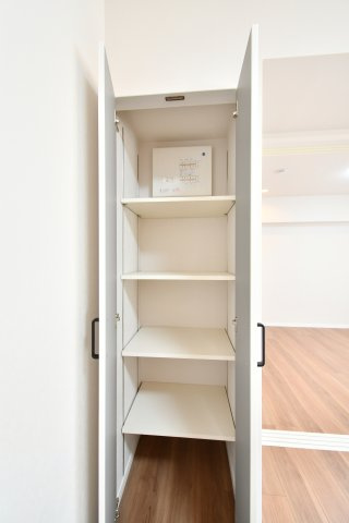 春日部ダイヤモンドマンションの収納|リビングに隣接する便利な収納スペース。掃除用具や日用品のストック、季節物までスッキリ収まります。可動棚仕様のため、ライフスタイルに合わせて高さを自由に変えられるのが魅力です。