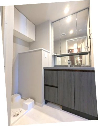 BPRレジデンス東日暮里の洗面所|トイレと独立した洗面脱衣室、三面鏡付ハンドシャワー付洗面台、洗面台の下にヘルスメーターストックあります、洗濯機置場は排水口のお手入れしやすい様に手前中央に配置し、足高の防水パンです