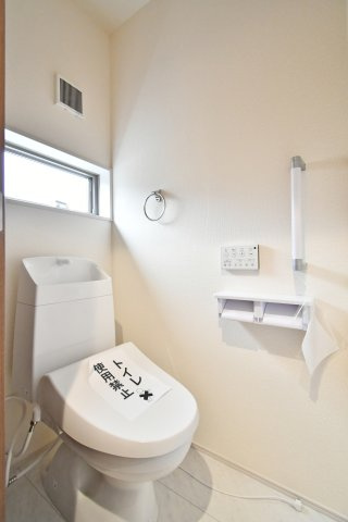 さいたま市岩槻区南辻第3　全8棟のトイレ|白を基調とした清潔感あふれるトイレ。手洗い付きの多機能便座に加え、立ち座りをサポートする手すりや小窓付きで、安全性と換気性にも配慮されています。毎日使う場所だからこそ、心地よさを追求した空間です。