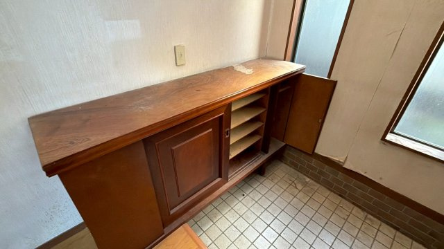 【湯河原町鍛冶屋】吹抜けがもたらす明るく開放的な室内の内装|重厚感のある木製の下駄箱。