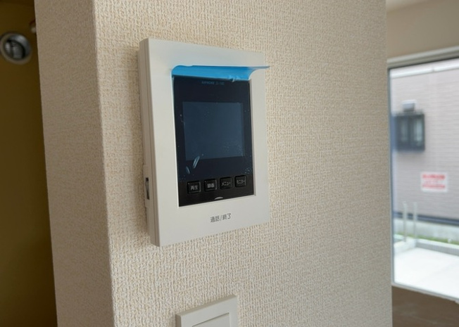 【セキュリティ】 | 防犯面に配慮したＴＶモニタ付インターホンを設置。訪問者の姿を室内から映像で確認してから対応できるため、お子様のお留守番時や一人で過ごす時間も安心です。配線もスッキリと壁面に収まっています。